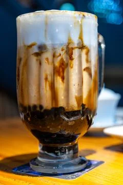 A close-up of classic brown sugar bubble tea with images of a crystal-clear.. Fotos de archivo