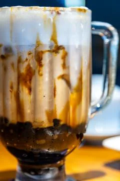 A close-up of classic brown sugar bubble tea with images of a crystal-clear.. 스톡 사진
