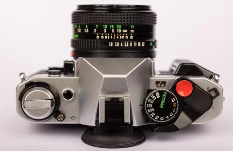 Close-up of a classic camera, featuring intricate controls, set against a p.. Stock Photos