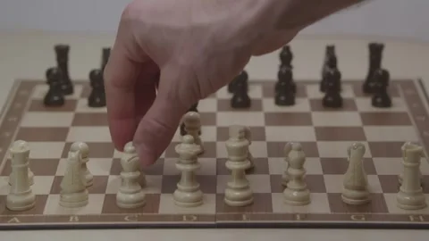Close-up of a classic chess game being played on a wooden board. Video stock 327208930