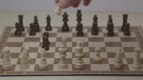 Close-up of a classic chess game being played on a wooden board. Video stock 327208942