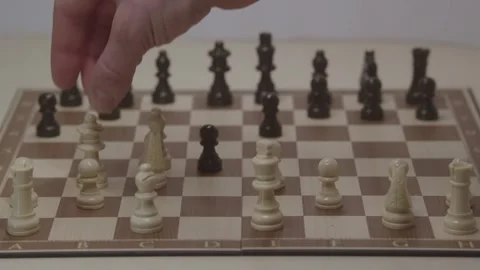 Close-up of a classic chess game being played on a wooden board. Video stock 327208994