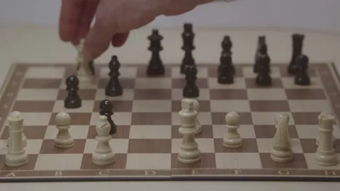 Close-up of a classic chess game being played on a wooden board. Video stock 327209049