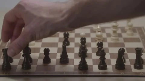 Close-up of a classic chess game being played on a wooden board. Video stock 327209321
