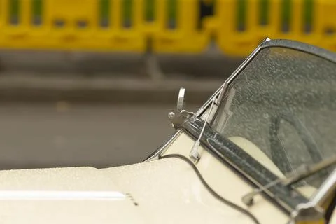 Close-up of classic convertible windshield and chrome mirror on cream car Stock Photos