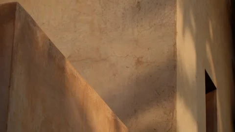 Close-up of classic Moroccan architecture with sun casting tree shadows on Stock Footage 315100148