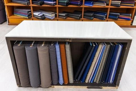 Close-up of classic traditional generic bespoke tailoring cutting table and bolt Stock Photos