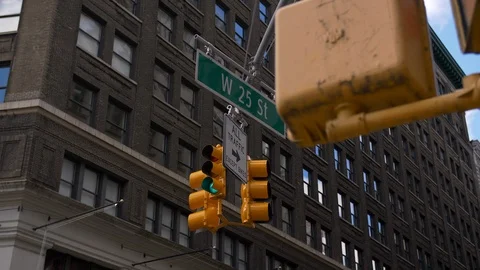 Close Up Of Classic Yellow Traffic Lights In NYC With Beautiful Skyscrapers  Stock Footage 113883004