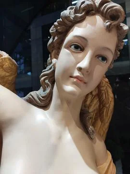 Close-Up of Classical Angel or Goddess Painted Resin Statue with Curly Hair Stock Photos