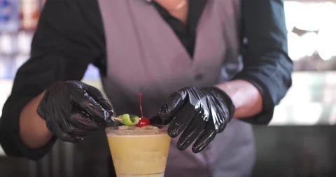 Close up of classy expert bartender making and serving yellow color cocktail 스톡 동영상 156796819