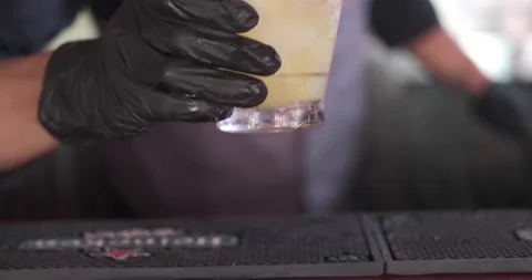Close up of classy expert bartender making and serving yellow color cocktail Video stock 156796829