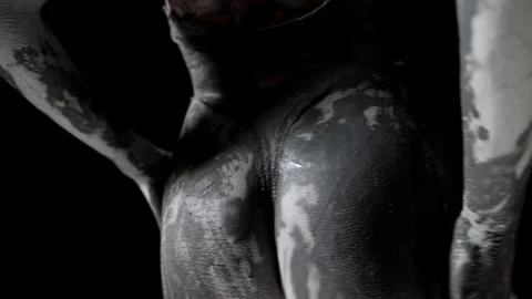 Close-up of clay-smeared hands and female buttocks. black and white video 動画素材 200808539