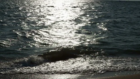 Close up of clean sea waves breaking on sandy beach with Sunset or sunrise light Stock Footage 157583300