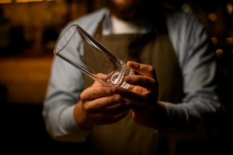 Close-up of clean transparent empty glass in male hands 스톡 사진