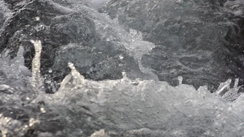 Close up of clean water flowing in a small mountain river, slow motion Video stock 127131384