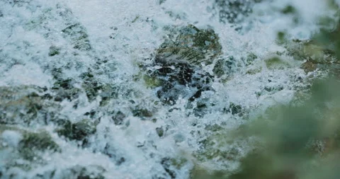 Close up of clean water flowing in a small mountain river Stock Footage 150984380