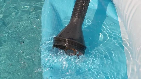 Close-up clean water is poured into an inflatable pool from a hose. Sunny day Stock Footage 220356915