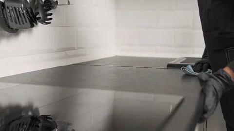Close-up cleaner wipes a kitchen counter, maintaining hygiene. General cleaning Stock Footage 295778785