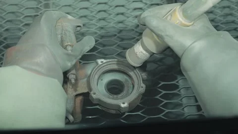 Close up cleaning and removing rust from car detail using a sandblasting machine Stock Footage 284545398