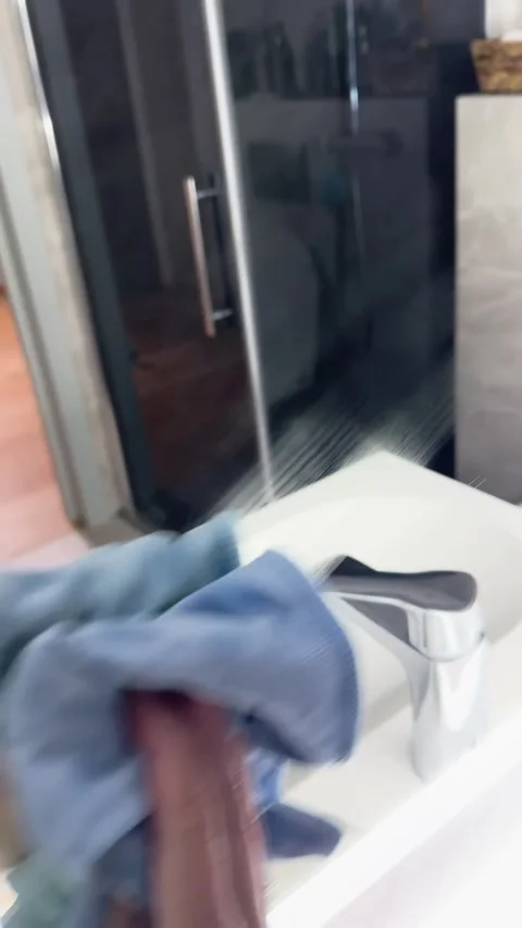 Close-up cleaning bathroom mirror vertical video Stock Footage 288240919