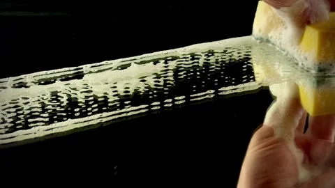 Close-up of Cleaning Bubbles and Foam on Black Glass Video stock 334320583