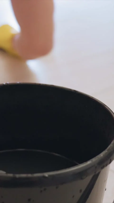 Close up of Cleaning Bucket and Mop in Action featuring floor water glove yellow Stock Footage 346787694