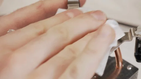 Close-up cleaning of computer's CPU cooling radiator. The service worker removes Stock Footage 105073216