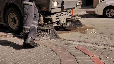 Close up. Cleaning Machine not removing trash from the streets. Worker having a Stock-Footage 125948282