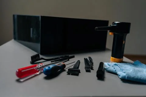 Close-up of cleaning open computer case with specialized tools, screwdrivers and Stock Photos