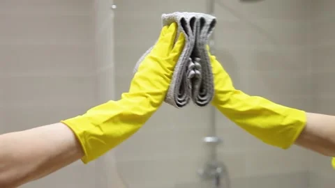 Close-up cleaning, reflection of hand in glove wiping mirror by cloth, side view Stock Footage 152605257