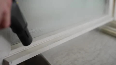 Close-up of cleaning service worker using steam cleaner for effectively removing Stock Footage 311053907