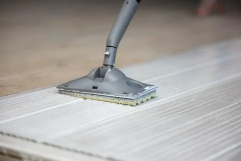 Close Up of Cleaning Tool with Gray Handle on Textured Surface Photos