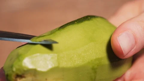 A close-up of the cleansing of the avocado from the peel. The process of cooking Stock Footage 126204062