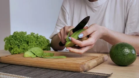 Close-up of the cleansing of the avocado from the peel. The process of cooking a Stock Footage 150803680