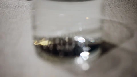 Close up of a clear glass of water on a table, with soft reflections and light Stock Footage 332515059