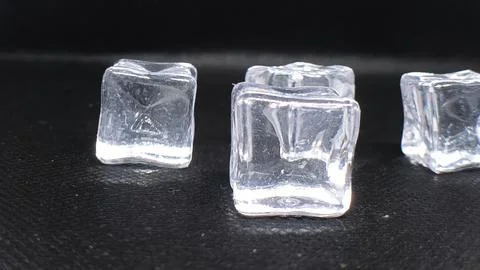 Close-up of clear ice cubes on a dark background, ideal for drink and refre.. Stock Photos