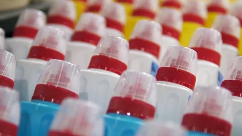 Close-up of clear lids of plastic jars of household chemicals standing in a row 스톡 동영상 313866722