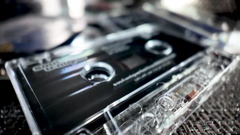 Close up of a clear plastic audio cassette tape case showcasing retro music Stock Footage 323085208