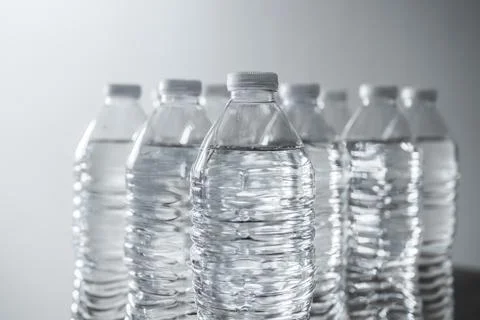 Close up of clear plastic water bottles with white caps Stock Photos
