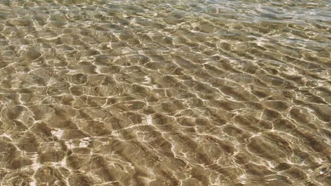 Close-up of clear water ripples, a dance of light and motion. Each splash in the Video stock 255464392