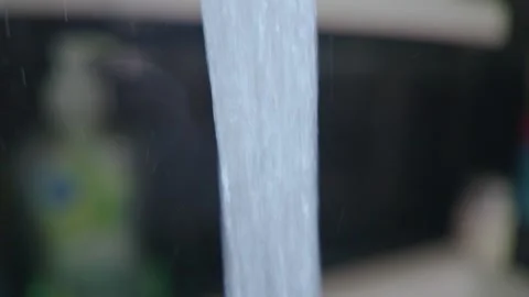 Close up of clear water stream flowing from a modern kitchen tap into a sink Stock Footage 339809534