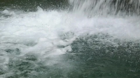 Close up of clear waterfall splashes falling into the river Stock Footage 321325840