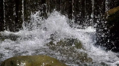 Close up of clear waterfall splashing on rocks Stock Footage 321798712