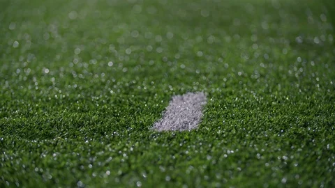 Close up of cleats running by a hash mark on a turf football field Stock Footage 77084507