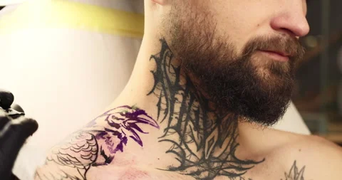 Close-up of a client with a calm balanced look while creating a tattoo Stock Footage 251380705