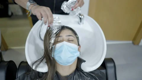 Close up of client getting hair prepared for a hair wash at the salon Video stock 205844734