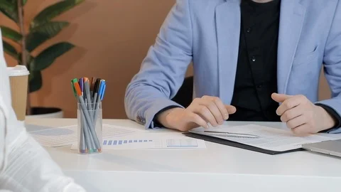 Close up client offers a bribe to an employee of the company in the office. The Stock Footage 125813258