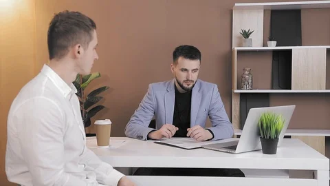 Close up client offers a bribe to an employee of the company in the office. The Stock Footage 127579938