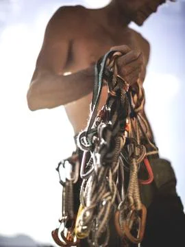 Close up of a climber holding a bundle of rope and carabiners, climbing Stock Photos