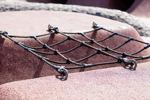 Close-up of a climbing net on a playground structure, highlighting the textures Stock Photos